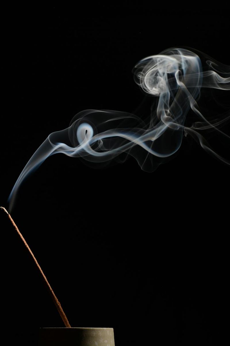 Incense smoke in a tranquil meditation room setting.