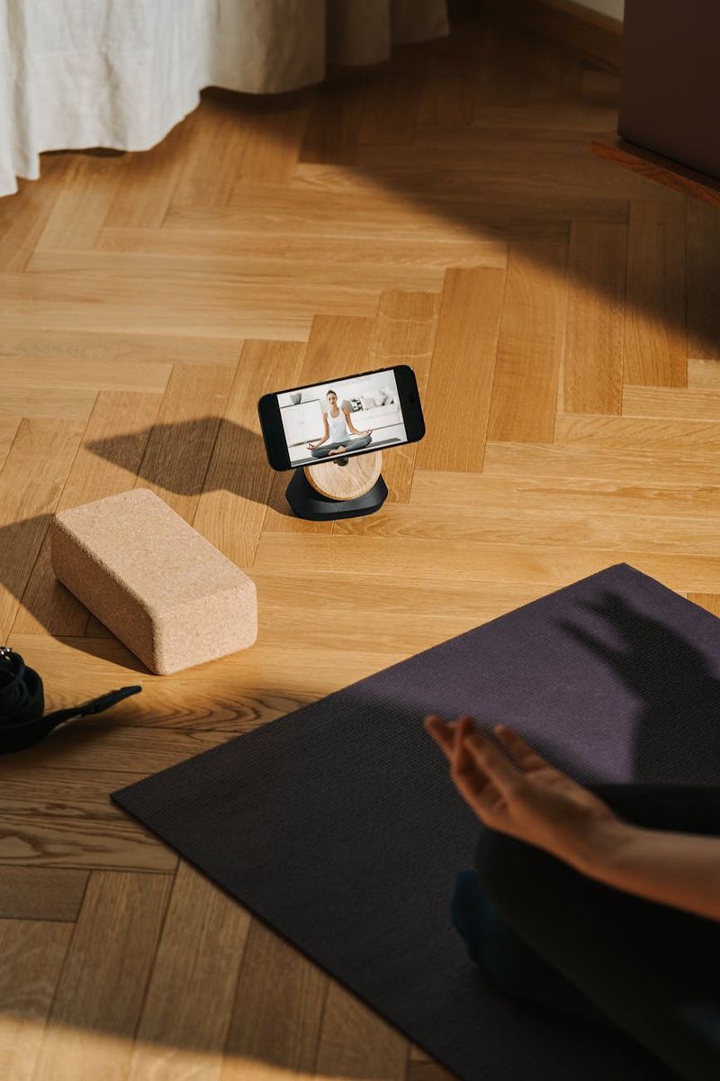Minimalist yoga studio with natural wooden floor and plants.